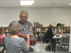 Al Humphrey and Brenda Stone discuss the arrangements for the Friday summer duplicate bridge session. 